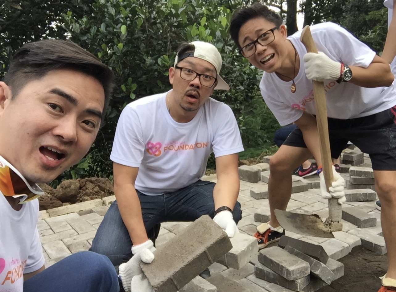 Laying thousands of bricks to help built a playground for the orphanage.